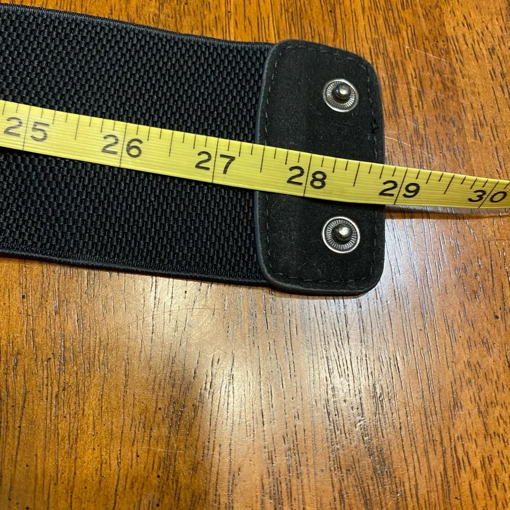 black belt with lace and sequins. Stretchy Size S/M. Snap closure.